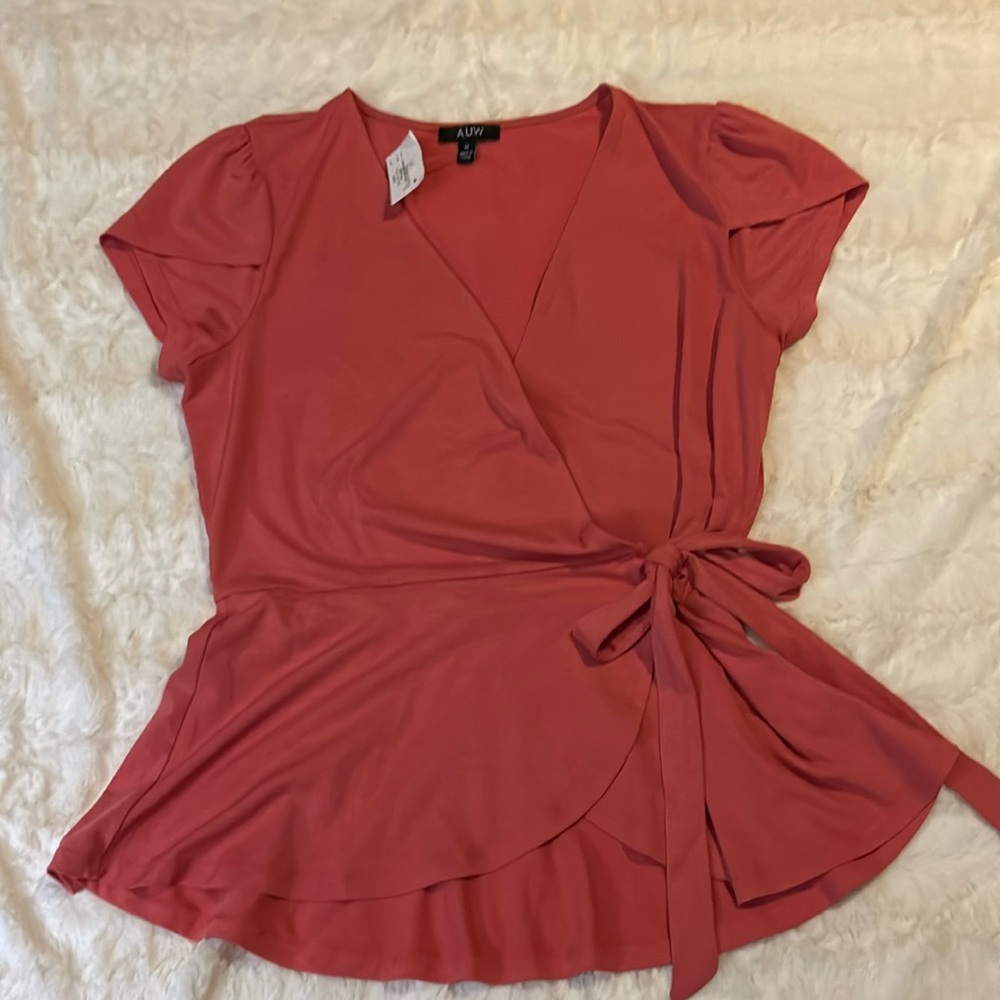 New with tags.  Peachy orange blouse